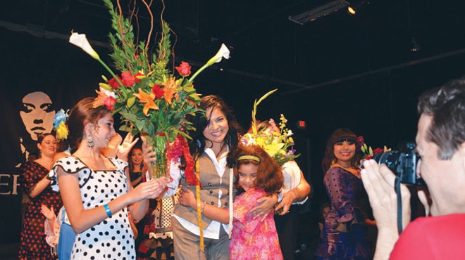 Lisa Perello (center) gets a hug from her daughter Andrea Palafox and flowers from Olive Stevens.