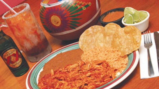 Tinga de pollo en tostadas, served hot with rice, beans, and a cold Dos Equis at Guajillo’s.