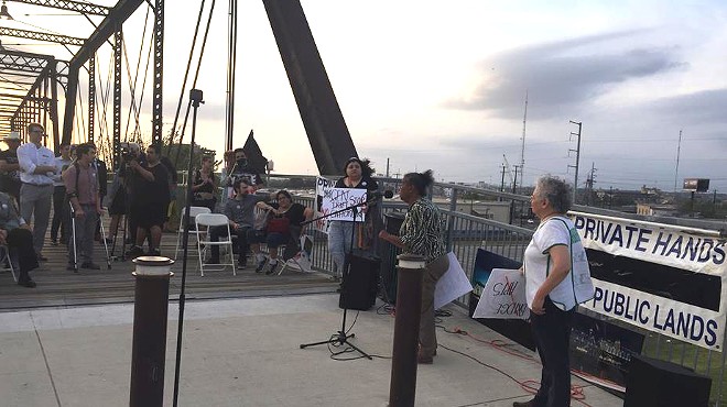 Neighborhood activist Nettie Hinton addresses the crowd at Hays Street Bridge on Monday.