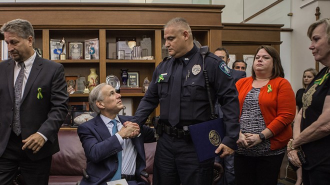 Greg Abbott shakes the hand of a participant in his school safety roundtable.
