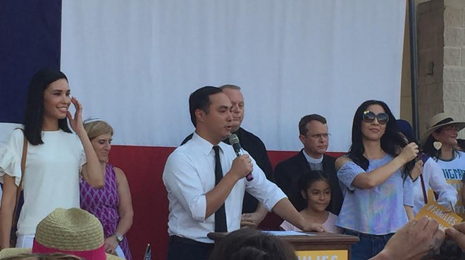 Joaquin Castro speaks at the West Side rally, surrounded by his family and local faith leaders.