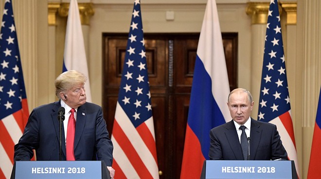 President Trump listens while Russian President Vladimir Putin speaks at the press conference following their Helsinki summit.