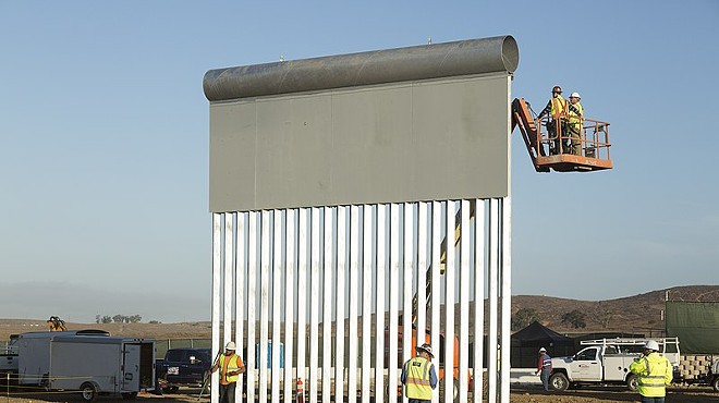 Workers construct a prototype of the proposed border wall near the Otay Mesa Port of Entry in San Diego.