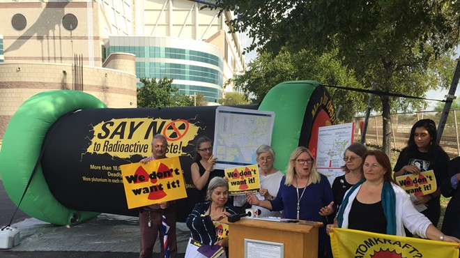 Environmental activists speak out against a plan to ship nuclear waste via Texas railways during a press conference in front of the Alamodome.