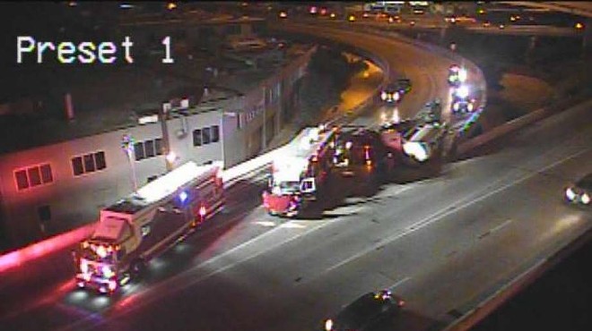 Emergency crews work to clear an overturned 18-wheeler at the Finesilver curve downtown.