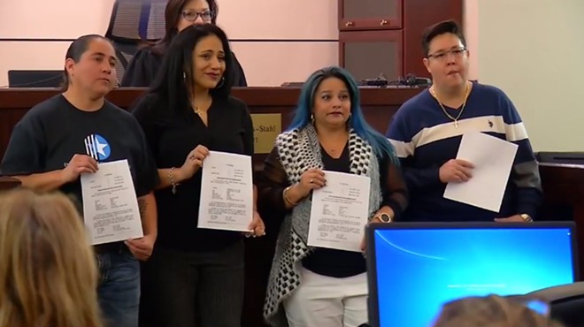 The women known as the San Antonio Four show off the papers expunging their criminal histories.