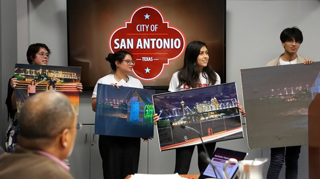 Briauna Barrera (from left), Natasha Hernandez, Yaneth Flores and Elionas Puente urge the City Council to act on a contentious piece of land north of the Hays Street Bridge. District 2 Councilman Art Hall (foreground), whose district encompasses the bridge, looks on.