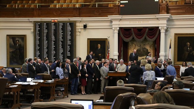 Texas lawmakers gather on the floor after passing an overhaul of the state's public chool finance system.