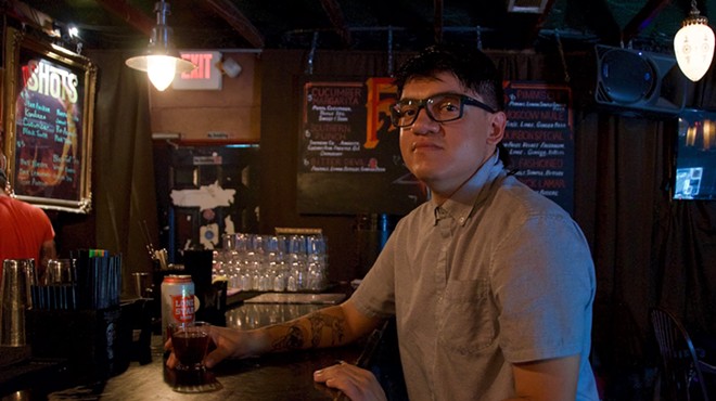 Sous chef JC Rodriguez enjoys a drink inside the cool and dark confines of Faust, his favorite local watering hole.