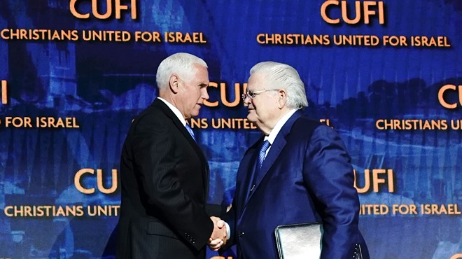 Pastor John Hagee (right) shakes the hand of Vice President Mike Pence at the CUFI summit in July.
