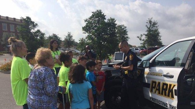 A park police officer shows off his patrol vehicle to visitors.