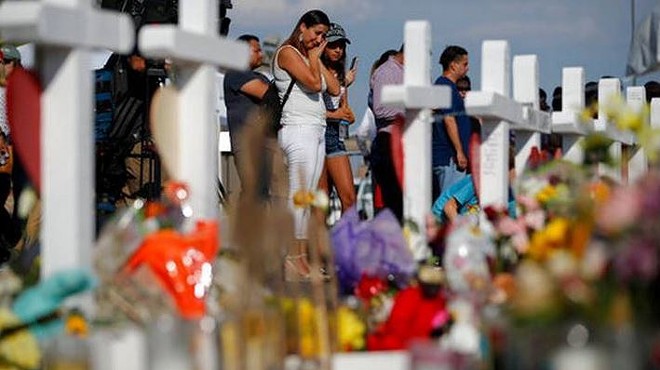 Mourners gather at a memorial for victims of the El Paso Walmart shooting.
