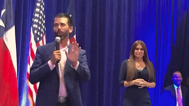 Donald Trump Jr. addresses the crowd while former Fox News personality Kimberly Guilfoyl looks on.