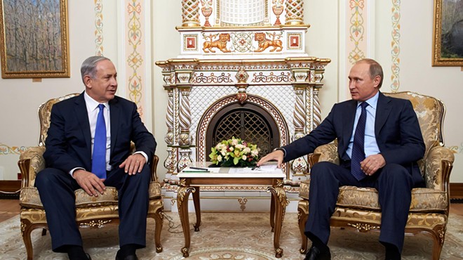 Israeli Prime Minister Benjamin Netanyahu sits with Russian President Vladimir Putin.
