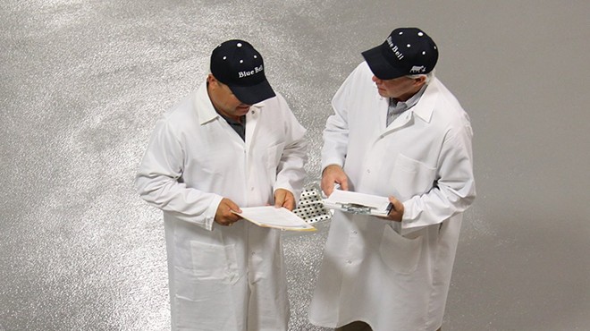 Two Blue Bell employees work on enhancements to the process at one of the company's facilities in this June, 2015 photo.