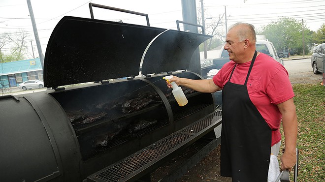 Andrew Garcia, co-owner of Garcia’s Mexican Food, 842 Fredericksburg Road, tends to briskets on the smoker behind the restaurant.