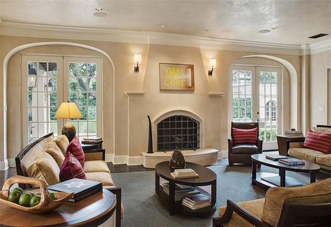 The sitting room offers plenty of natural light with windows on both sides of the fireplace.