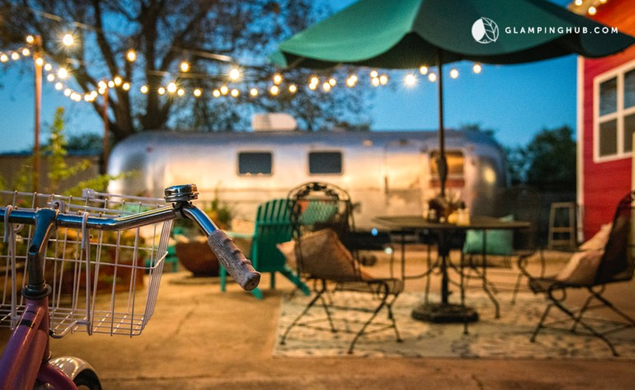 An outdoor seating area with beautiful string lights waits for guests.