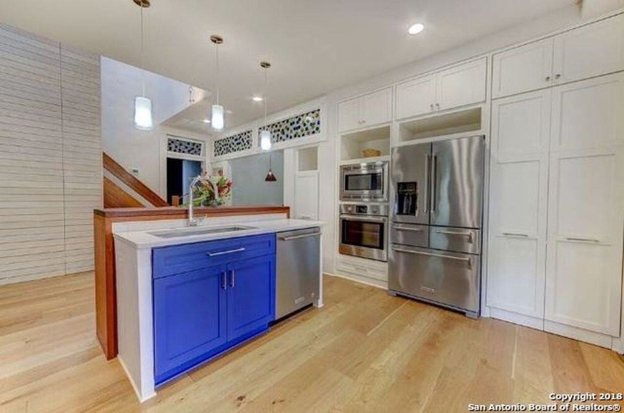 With colorful cabinets and sleek appliances, this kitchen will make your friends envious.