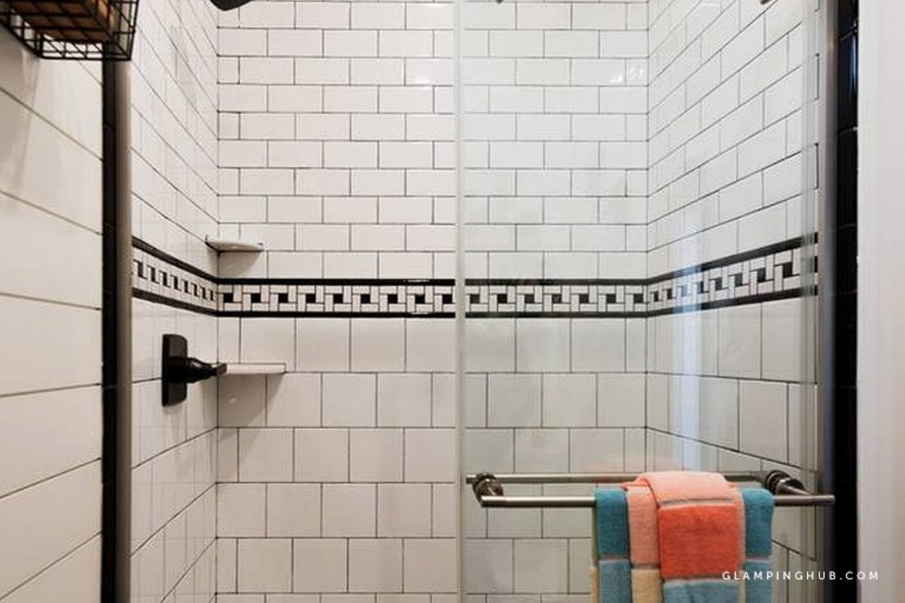 The bathroom also features a custom-tiled shower.