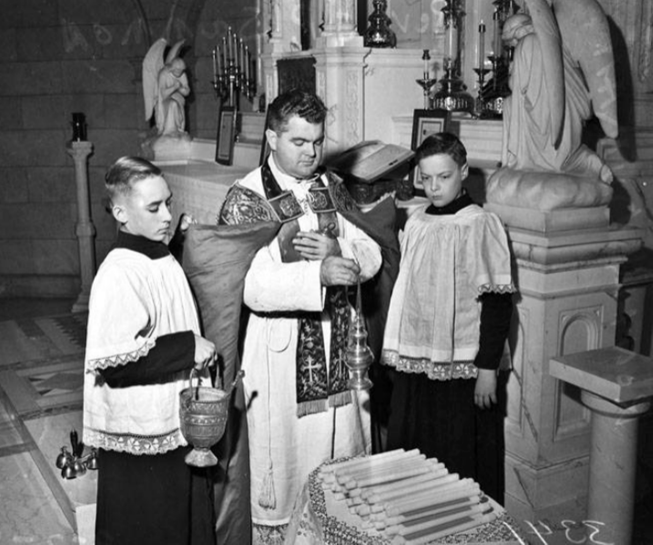 In this photo from the late 1940s, you can see Rev. Joseph P. Sammon of St. Mary's Catholic Church blessing the candles, with the assistance of two altar bars, in a ceremony known as "Candlemas." The event marked the end of the Christmas religious season for the church.