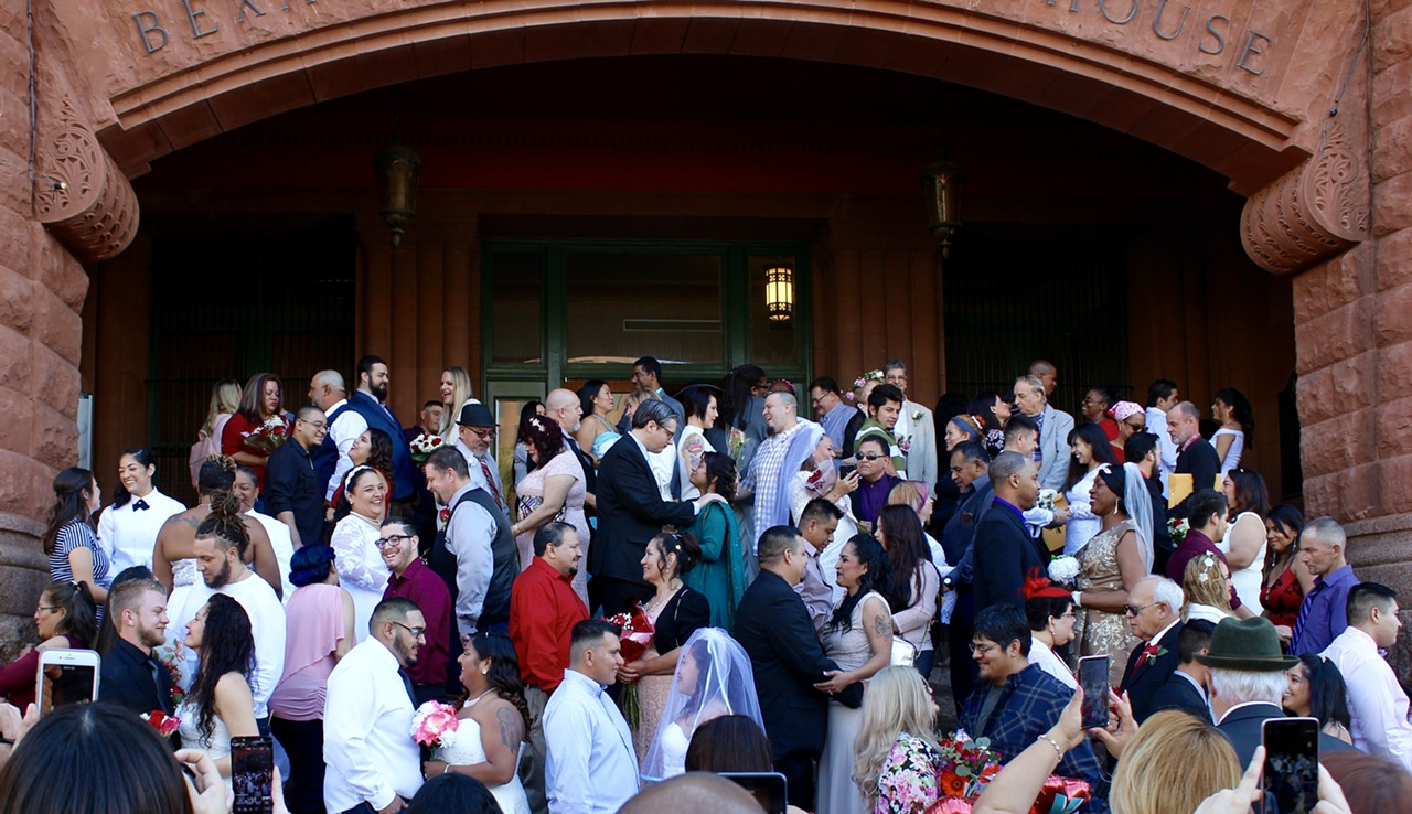 Couples just before saying "I do" in the free mass wedding ceremony in front of the Bexar County Courthouse.