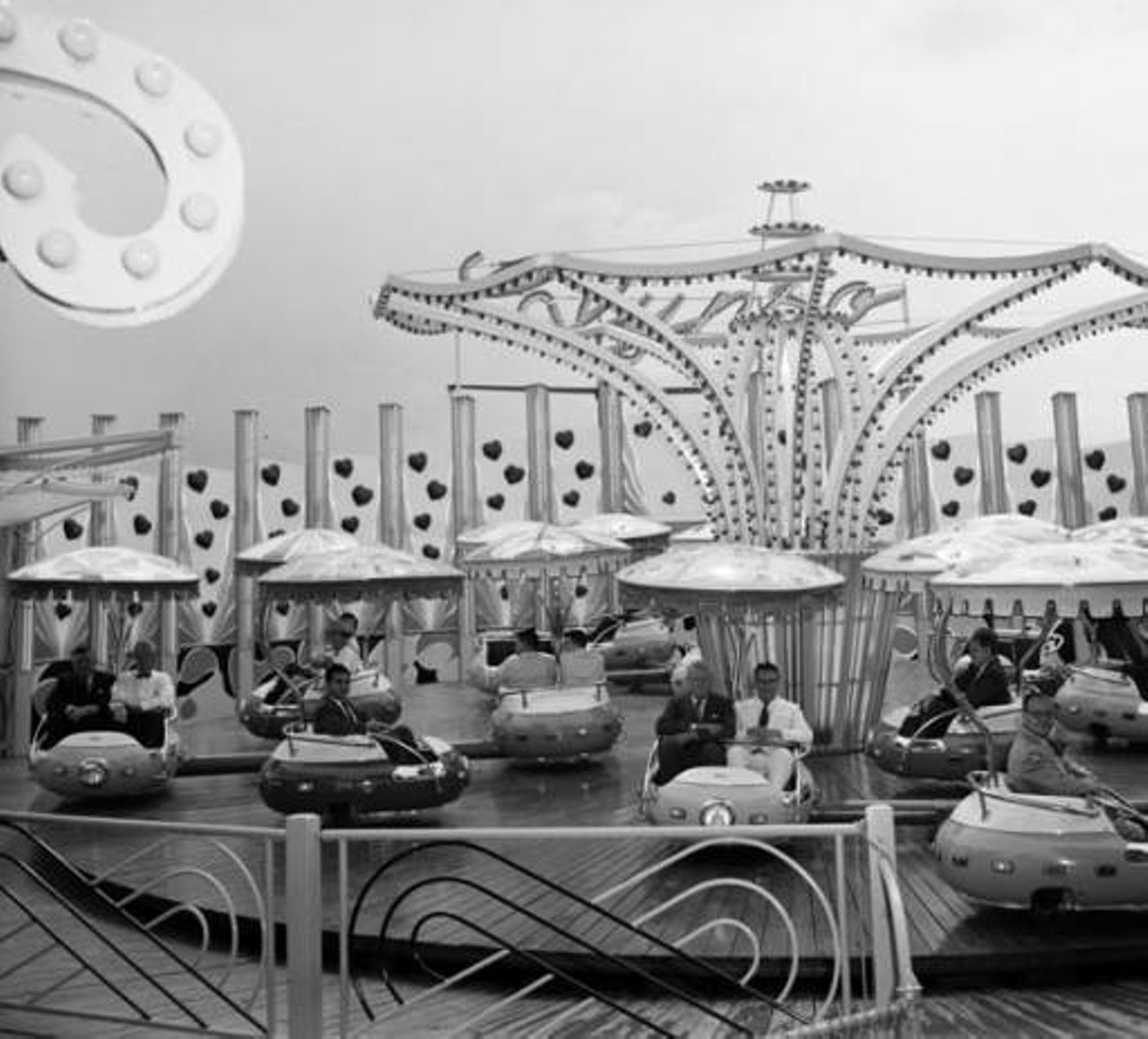 Businessmen on Carnival Ride, circa 1962
How safe could a carnival ride be in the 60s? According to OSHA, even today’s rides are probably not as safe as you would want them to be, but just look at this photo!
Photo via Zintgraff Studio Photo Collection