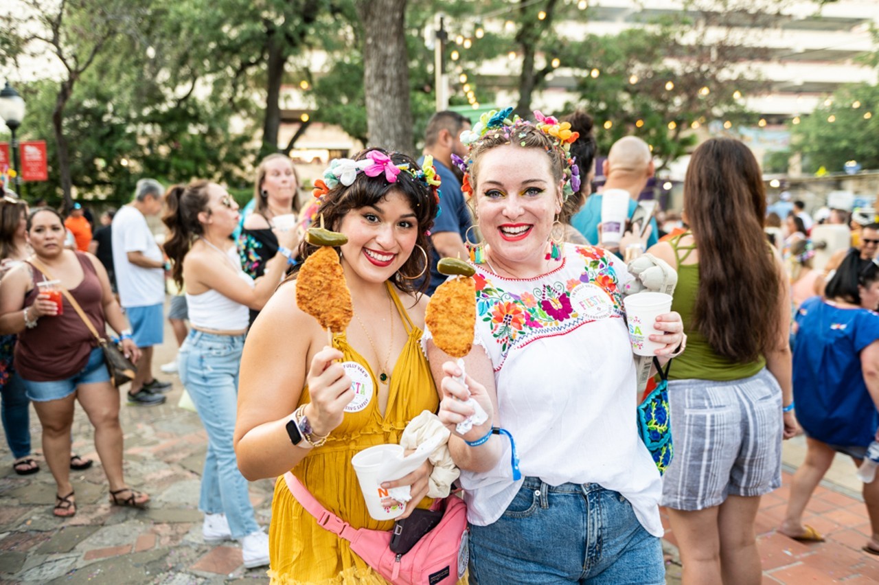 Chicken-on-a-Stick
Fiesta favorite chicken-on-a-stick is basically the supreme food booth snack from all of Fiesta. San Antonians look forward to eating it all year, and usually commemorate their first chicken-on-a-stick of the season with a selfie. It’s inspired chicken-on-a-stick necklaces, earrings, stickers and more from local designers, and has appeared on menus across SA so folks can get their fix. Thank goodness for that.
Photo by Jaime Monzon