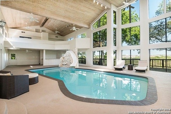 200 Canada Verde St.
$750,000
We get that you might not want to encourage big splashes in an indoor pool, but with ceilings that high we’re surprised they didn’t go for a taller slide.