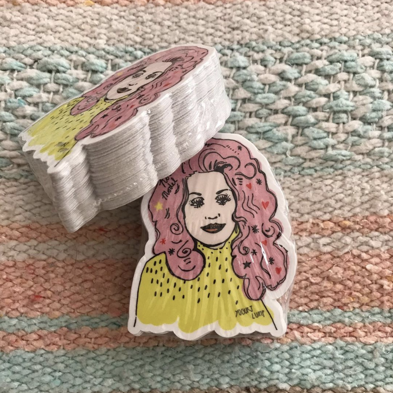 @yogurtlump
Jen Frost Smith makes colorful illustrations, enamel pins, stickers and more as Yogurt Lump. Smith's Dolly Parton illustration is also Ruby City's 2020 Fiesta Medal. 
Photo via Instagram / yougurtlump