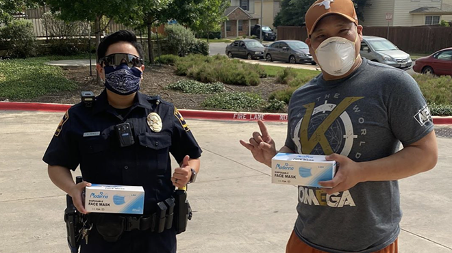 Chef Mike Nguyen (right) shares a mask and a meal with a member of law enforcement.