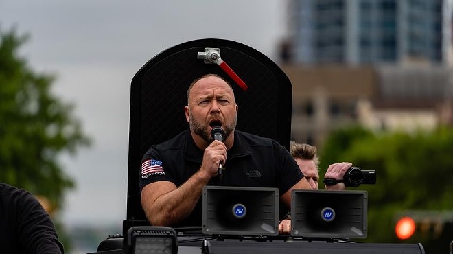 InfoWars founder Alex Jones speaks to a crowd over a loudspeaker from his InfoWars vehicle as hundreds attended a “Re-Open America” protest near the Texas Capitol in Austin in 2020. Jones filed for bankruptcy on Friday, Dec. 2, 2022.