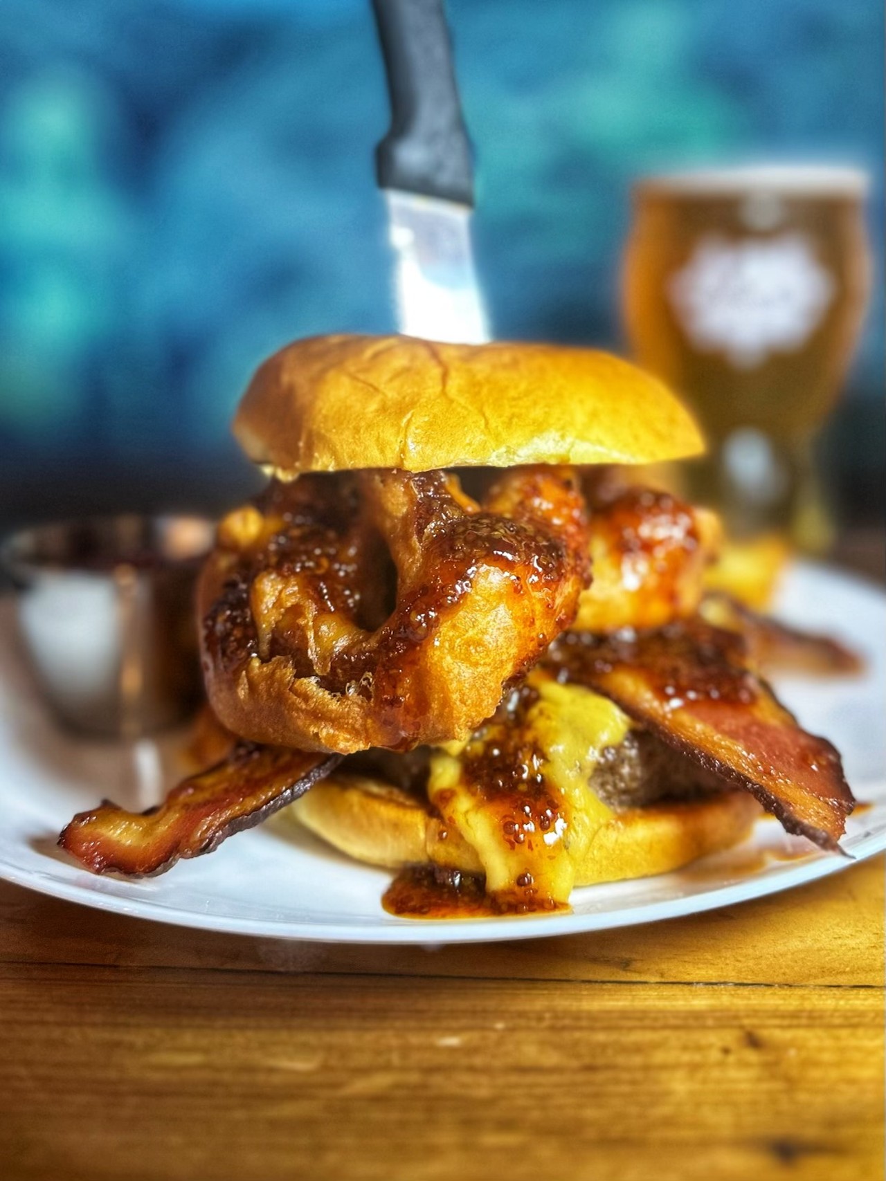 Dos Sirenos
231 E Cevallos St
$12 Triple Beer Brewhouse Burger6oz Texas wagyu patty, beer cheese, beer bacon, beer battered onion ring, chipotle honey mustard on a challah bun.