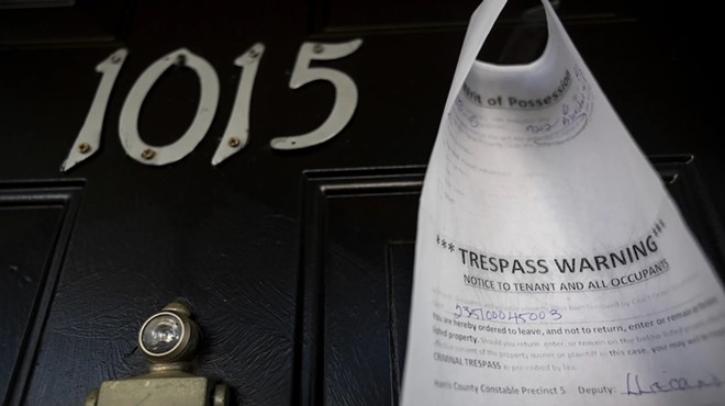 A writ of possession is taped to the door of an apartment at the Life at Jackson Square apartments on April 11, 2023, in Houston.