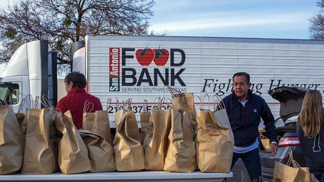 San Antonio Food Bank volunteers help hand out groceries.