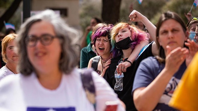 Atlas, left, and Sam, right, chant in front of the Texas Capitol during a protest for transgender kids' rights on Tuesday, March 1, 2022. Sam said he came "so kids like me don't have to go through the hard strifes of CPS or health care procedures to feel like themselves."