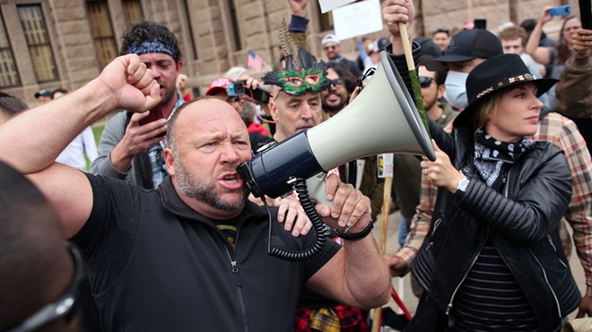 Right-wing conspiracy theorist Alex Jones speaks to a crowd protesting COVID-19 lockdown mandates during a protest in Austin in 2020.