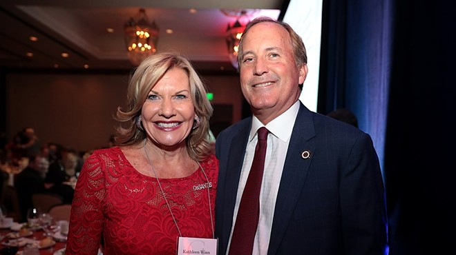 Texas Attorney General Ken Paxton (right) grins for a photo op.