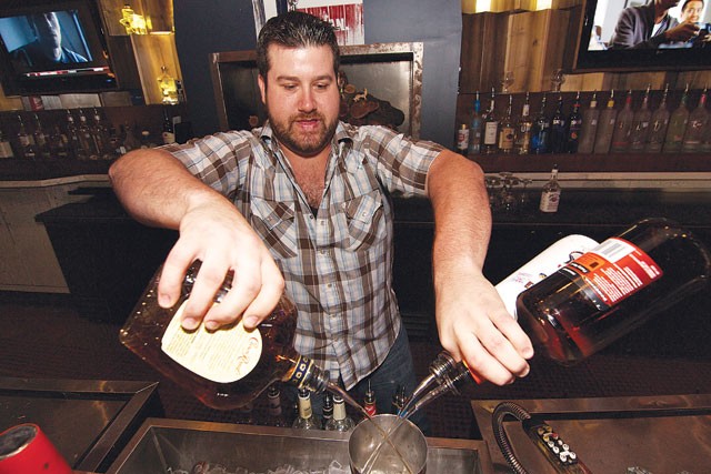 Bartender Chad Buckley mixes it up at Redland Roadhouse. - STEVEN GILMORE
