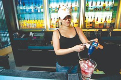 Bartender Meagan Ochoa mixes a drink at Wxyz Bar in the Aloft Hotel.