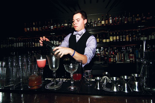 Bartender Stephan Mendez shakes and stirs at 1919. - MIKE BARAJAS