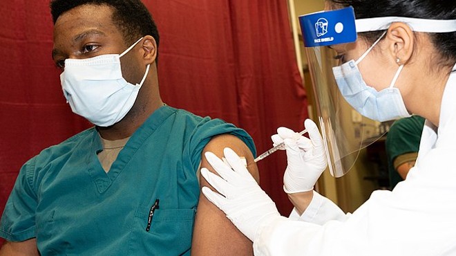 A patient receives a COVID-19 vaccine at a medical facility in Maryland.