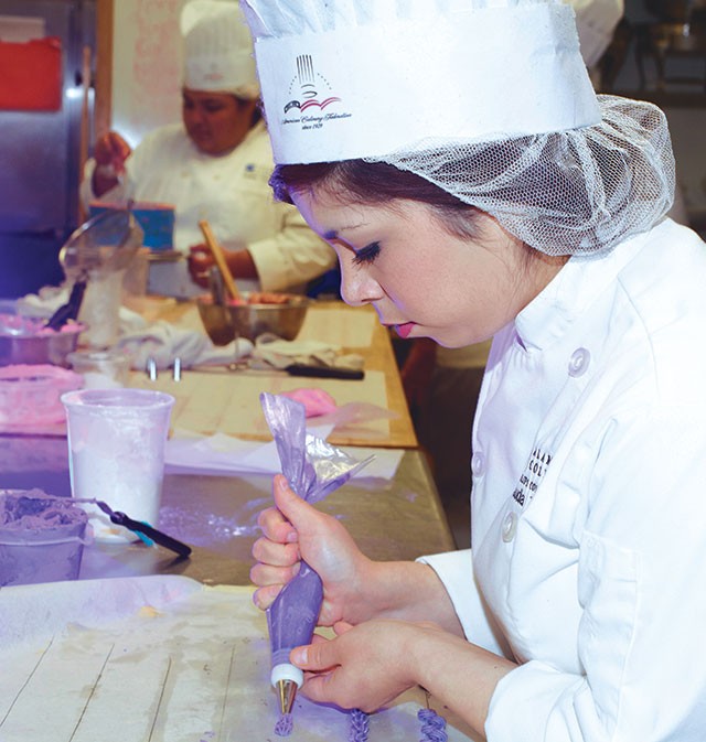 Claudia Treviño practices piping in her cake decorating class. - ESSENTIALS210