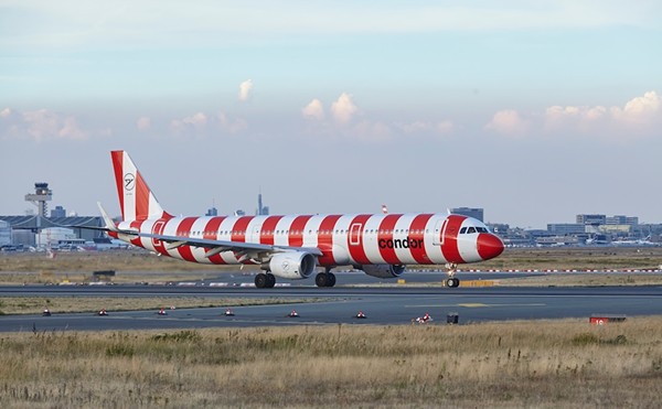 A red and white striped Condor aircraft lands at Frankfurt Main Airport in 2022.