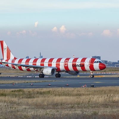 A red and white striped Condor aircraft lands at Frankfurt Main Airport in 2022.
