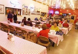 Diners enjoy their BBQ in the indoor dining room at Rudy's Country Store and Bar-b-que in Selma on a recent Thursday evening.