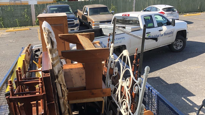 A Habitat for Humanity truck hauls away furniture and building supplies salvaged by Junk King San Anotnio.