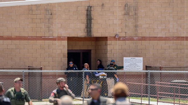 Authorities gather outside of Robb Elementary School in Uvalde after a gunman entered and killed 19 students and two teachers on May 24, 2022.