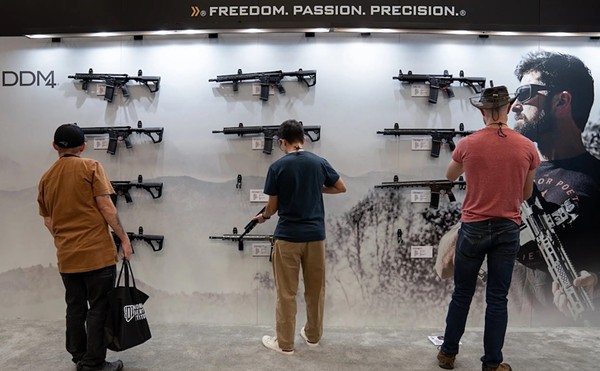 Attendees browse the Daniel Defense firearms booth at the NRA Annual Meetings and Exhibits at the Kay Bailey Hutchison Convention Center in Dallas on May 17, 2024.