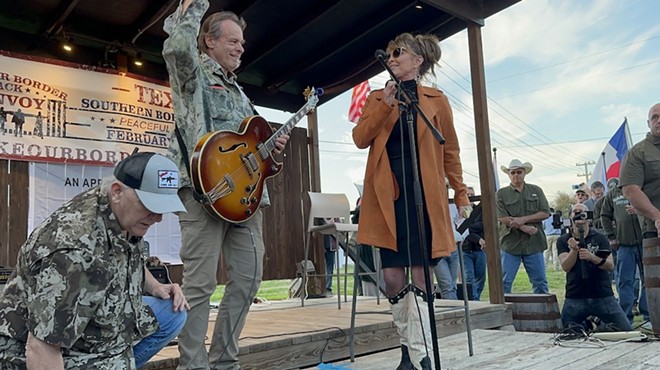 Former Alaska Gov. Sarah Palin and psychedelic guitarist turned right-wing activist Ted Nugent jump on stage at the Dripping Springs border rally on Thursday.